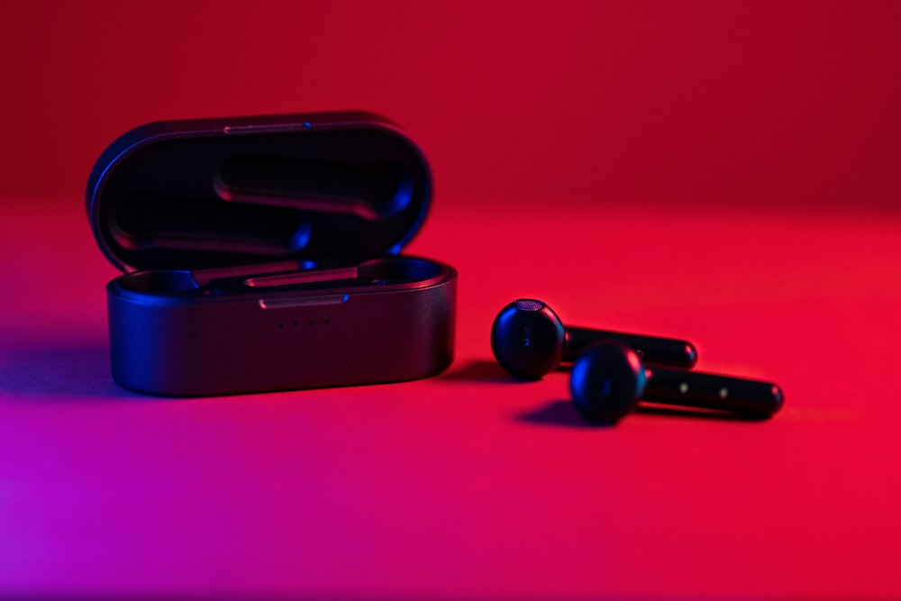 black and blue bluetooth earbuds