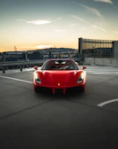 Sleek red Mazda SUV parked on a city street at sunset.