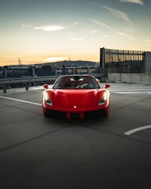 red ferrari sports car on road during daytime