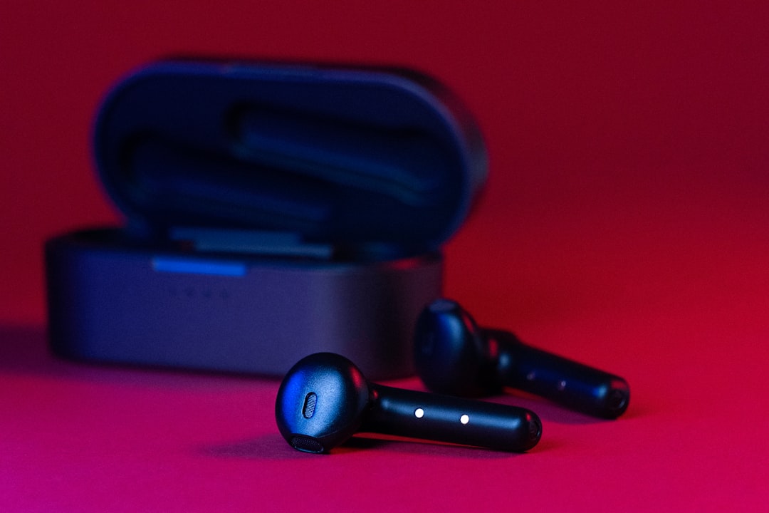 black and gray bluetooth earbuds