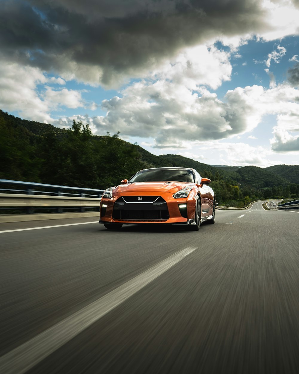 orange chevrolet camaro on road during daytime