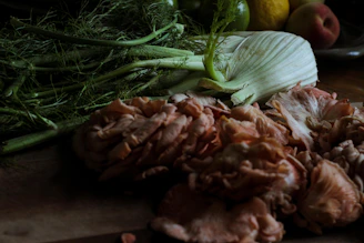 Close-up of fresh natural ingredients like leaves and berries arranged on a wooden table.