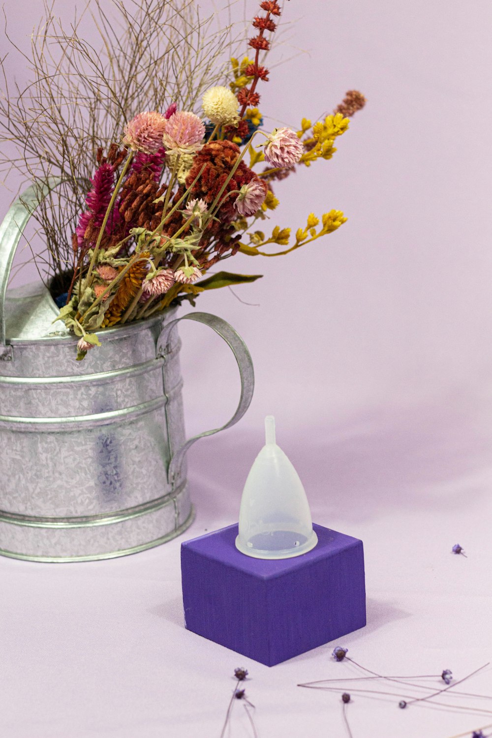 yellow flowers in gray steel vase