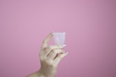 person holding white plastic cup