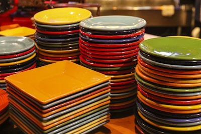 Stack of colorful targets with varying shapes and sizes on a wooden table.