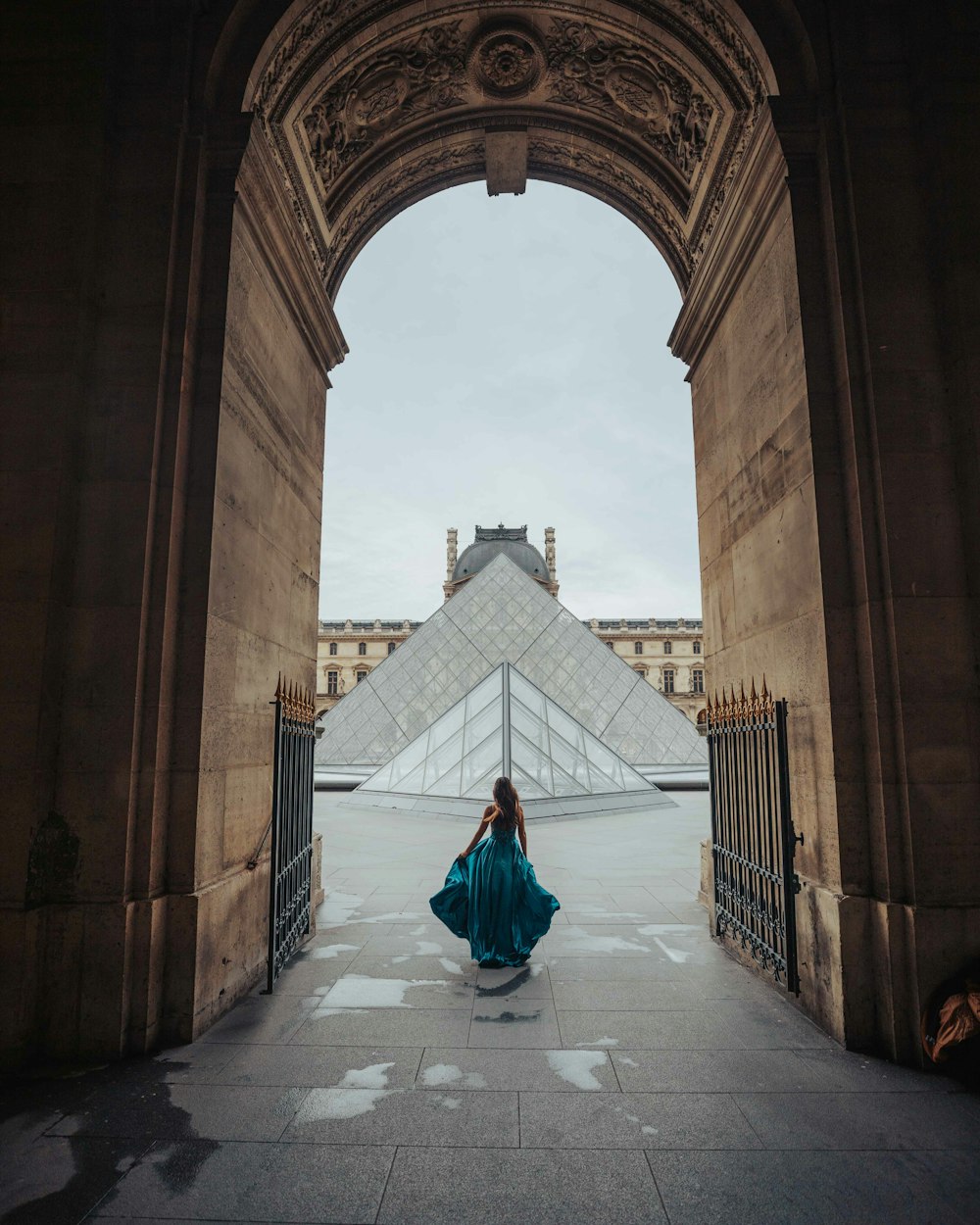 woman in green dress walking on hallway