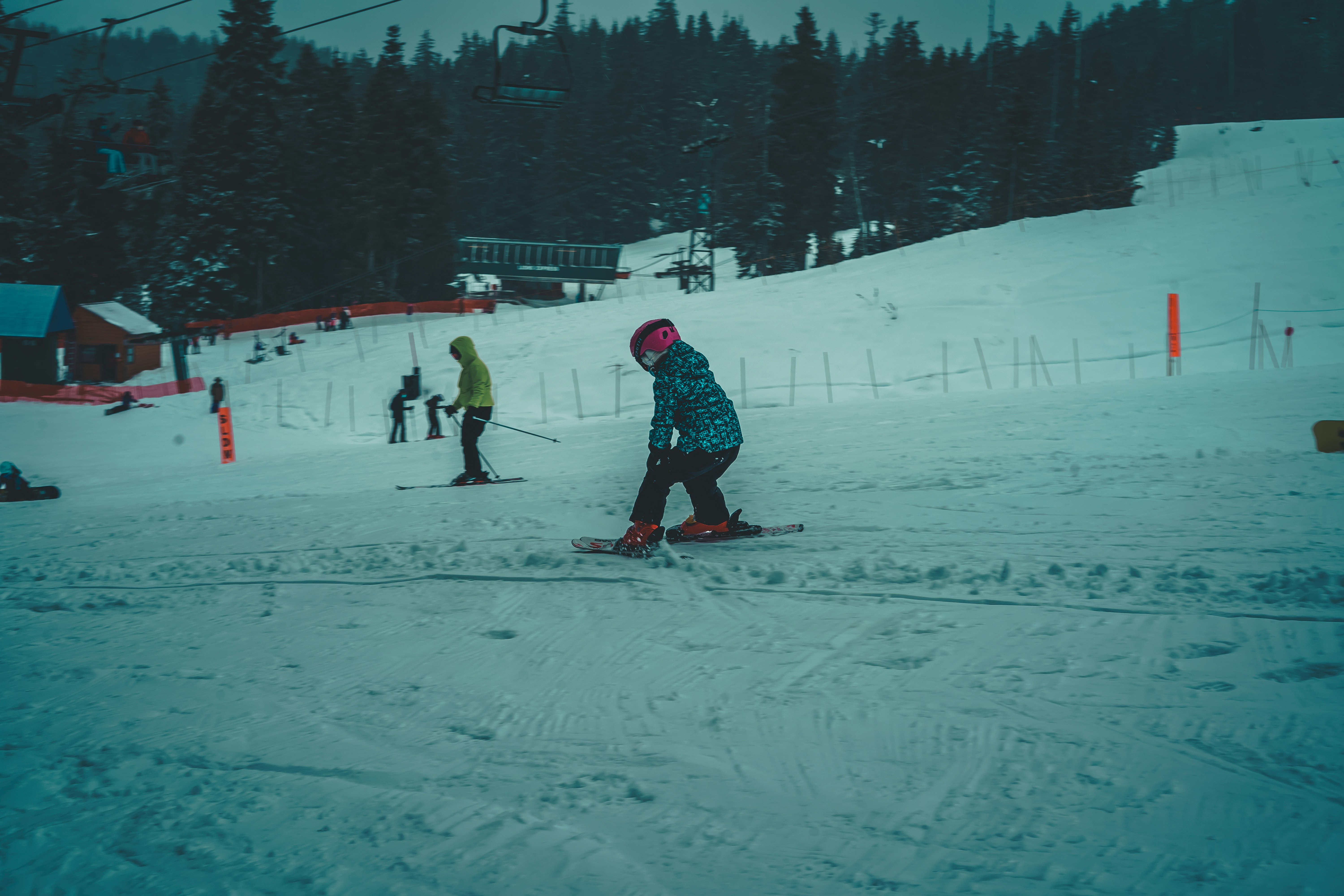 people playing ice hockey on snow covered field during daytime
