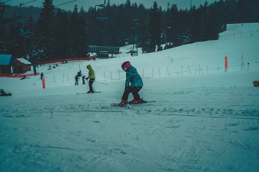 people playing ice hockey on snow covered field during daytime