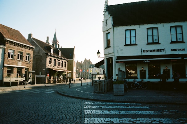 A picturesque view of a Belgian street lined with cafes.