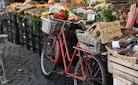 red city bike with basket of fruits