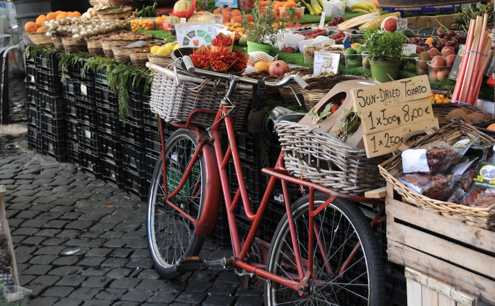 red city bike with basket of fruits