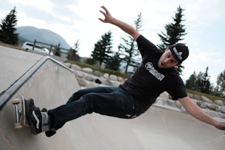 man in black crew neck t-shirt and blue denim jeans jumping
