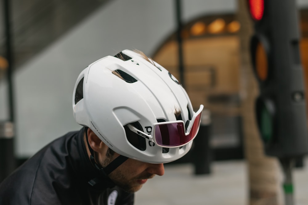 man in black jacket wearing white and red helmet