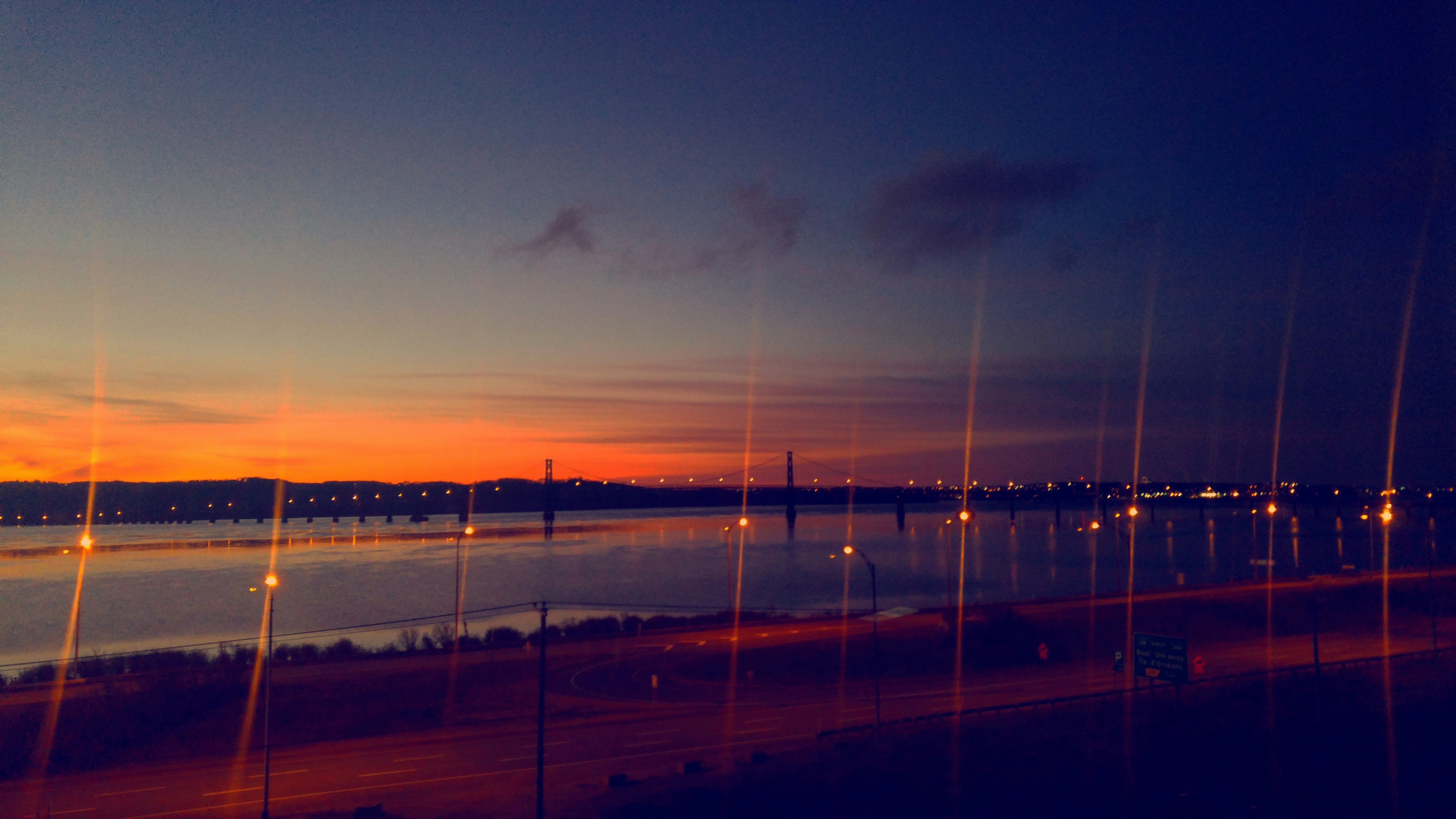 body of water near city during sunset