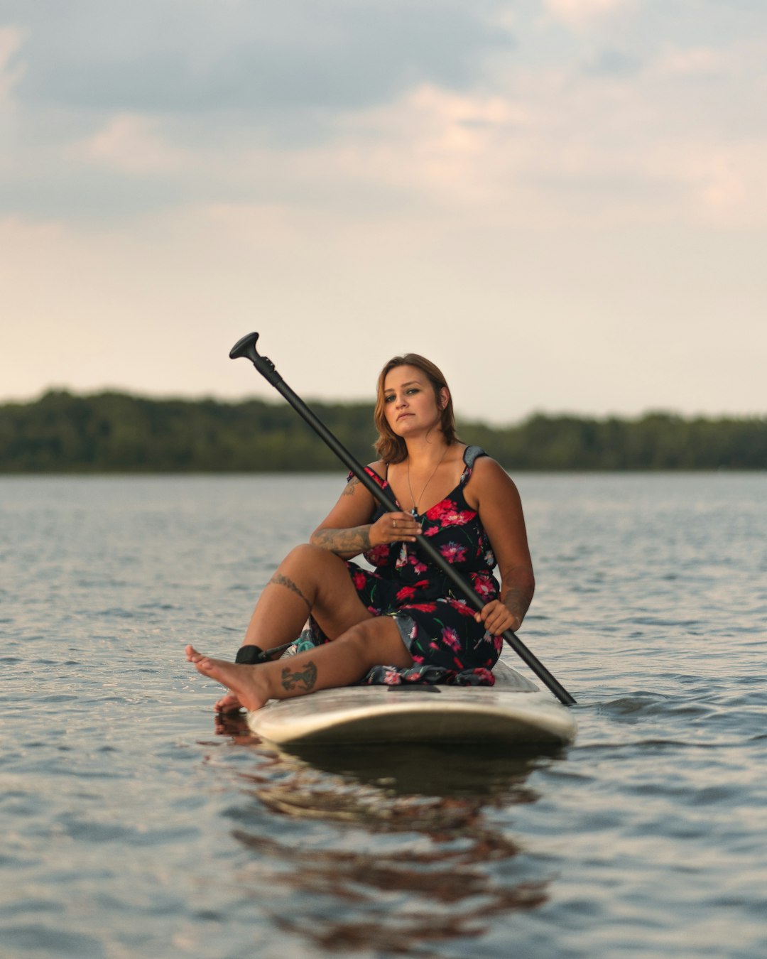 woman in red and black bikini riding on white and brown boat on body of water