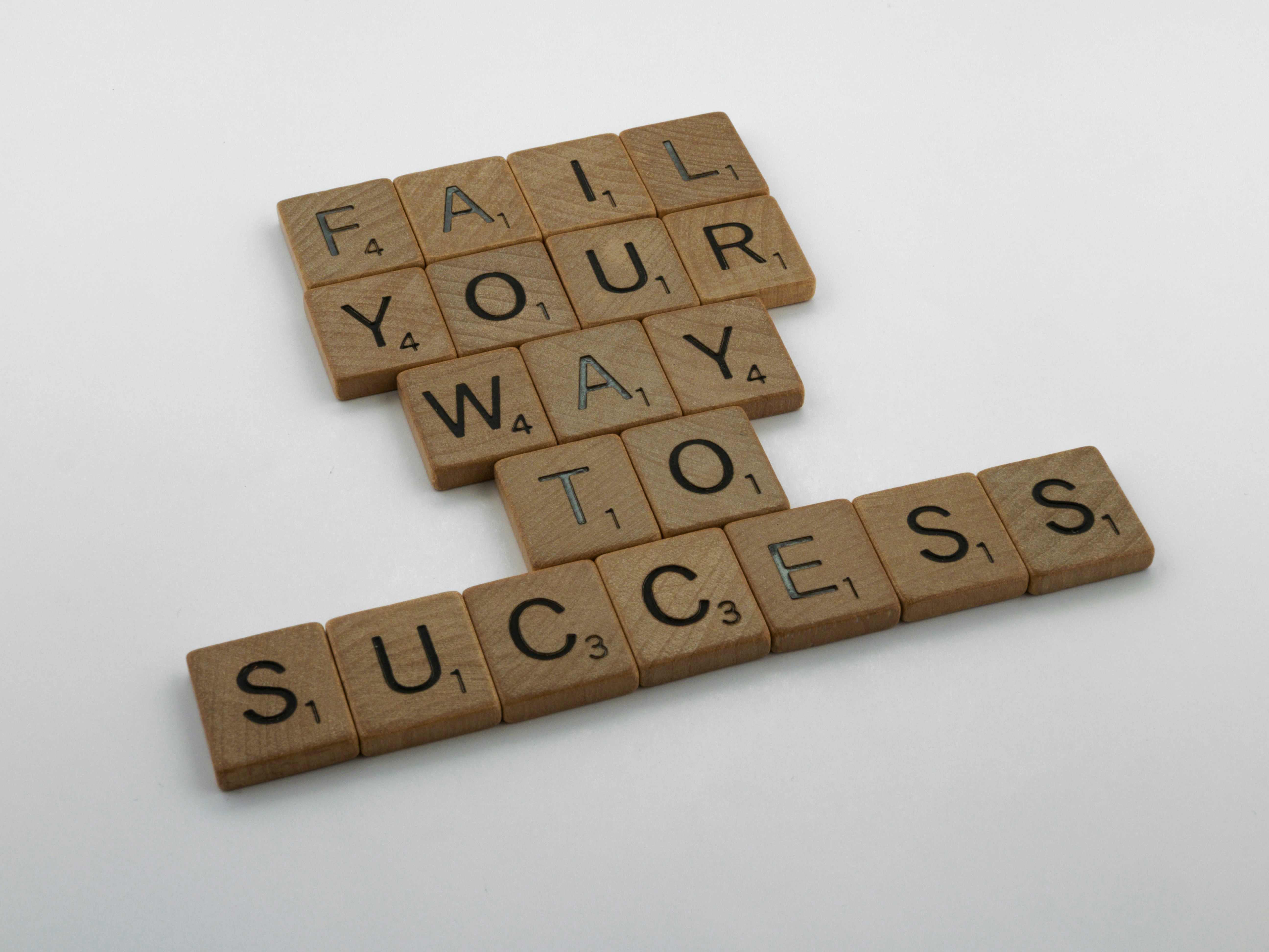 scrabble, scrabble pieces, lettering, letters, wood, scrabble tiles, white background, words, quote, fail your way to success, persevere, don't give up, try again, get up, move on, keep innovating,  