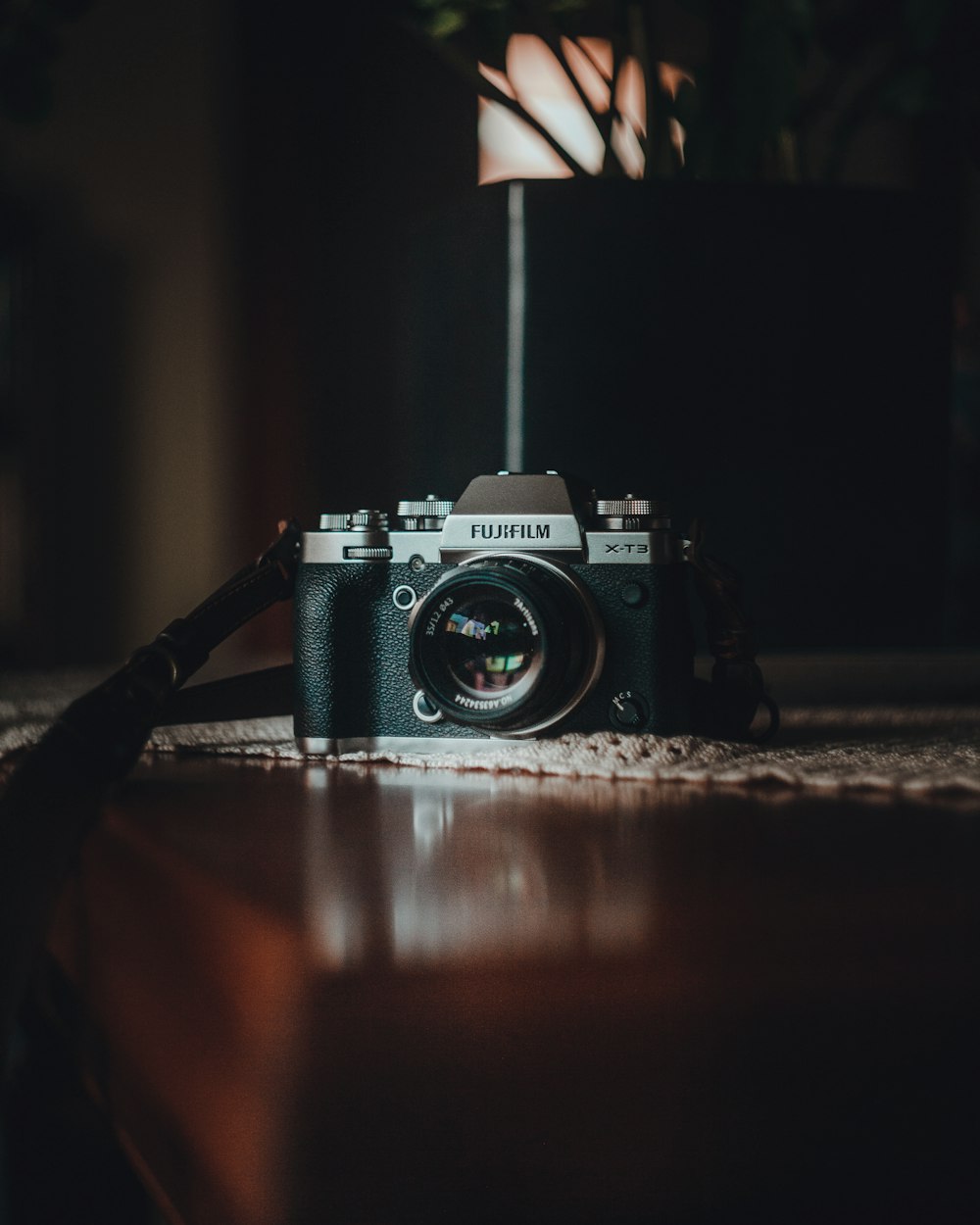 black and silver nikon dslr camera on brown wooden table