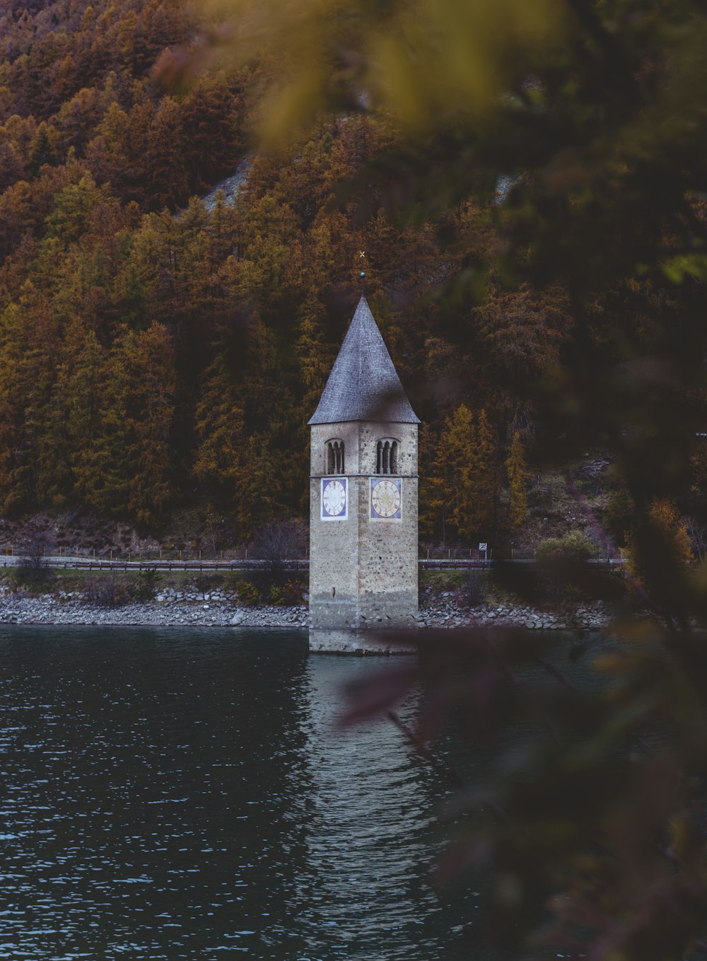 white and brown concrete building near body of water