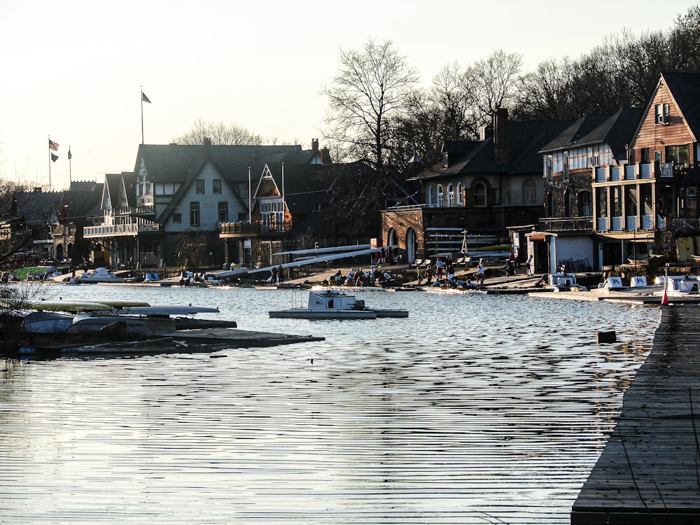 white and brown wooden house on body of water during daytime