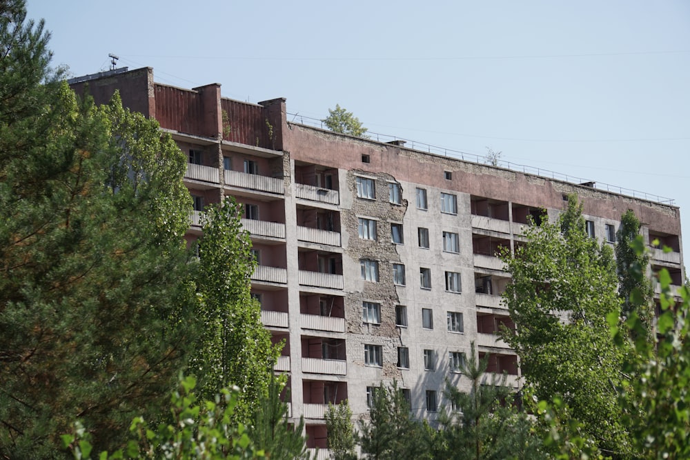 brown concrete building near green trees during daytime