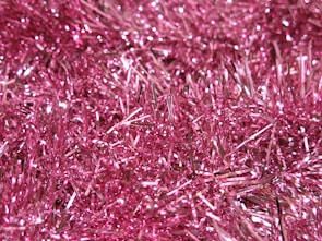 A woman showcasing her sparkling hair adorned with tinsel.