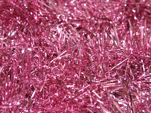 A close-up of hair tinsel being applied to a stylish hairstyle.