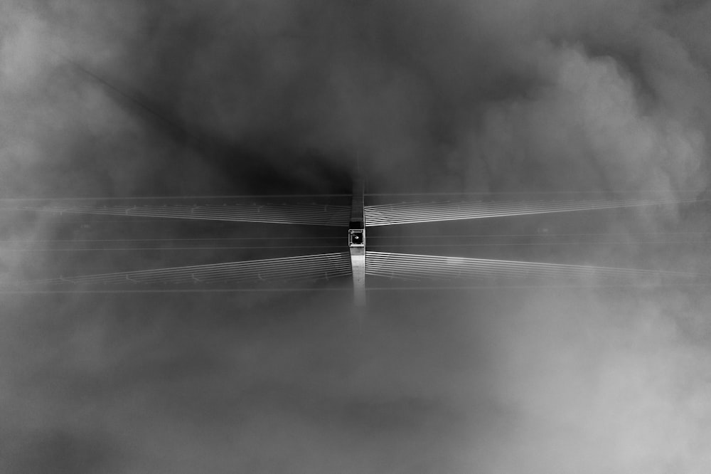 grayscale photo of a person walking on a road