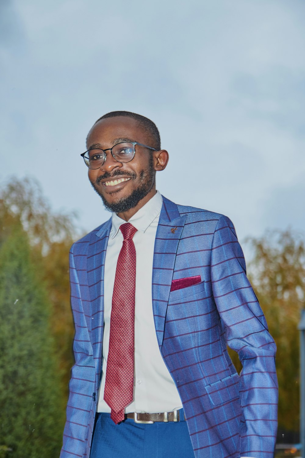 man in blue suit jacket wearing eyeglasses