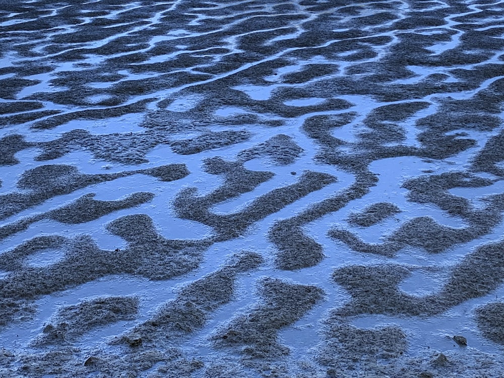 brown sand with water during daytime