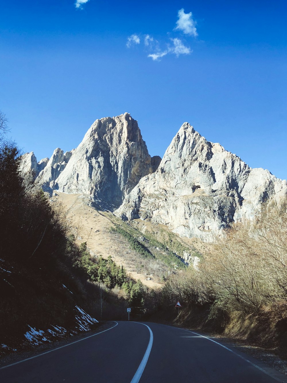 gray rocky mountain under blue sky during daytime