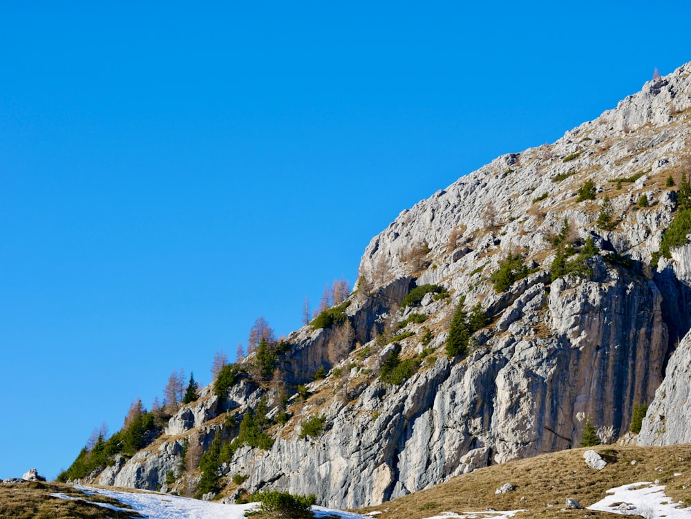 gray rocky mountain under blue sky during daytime