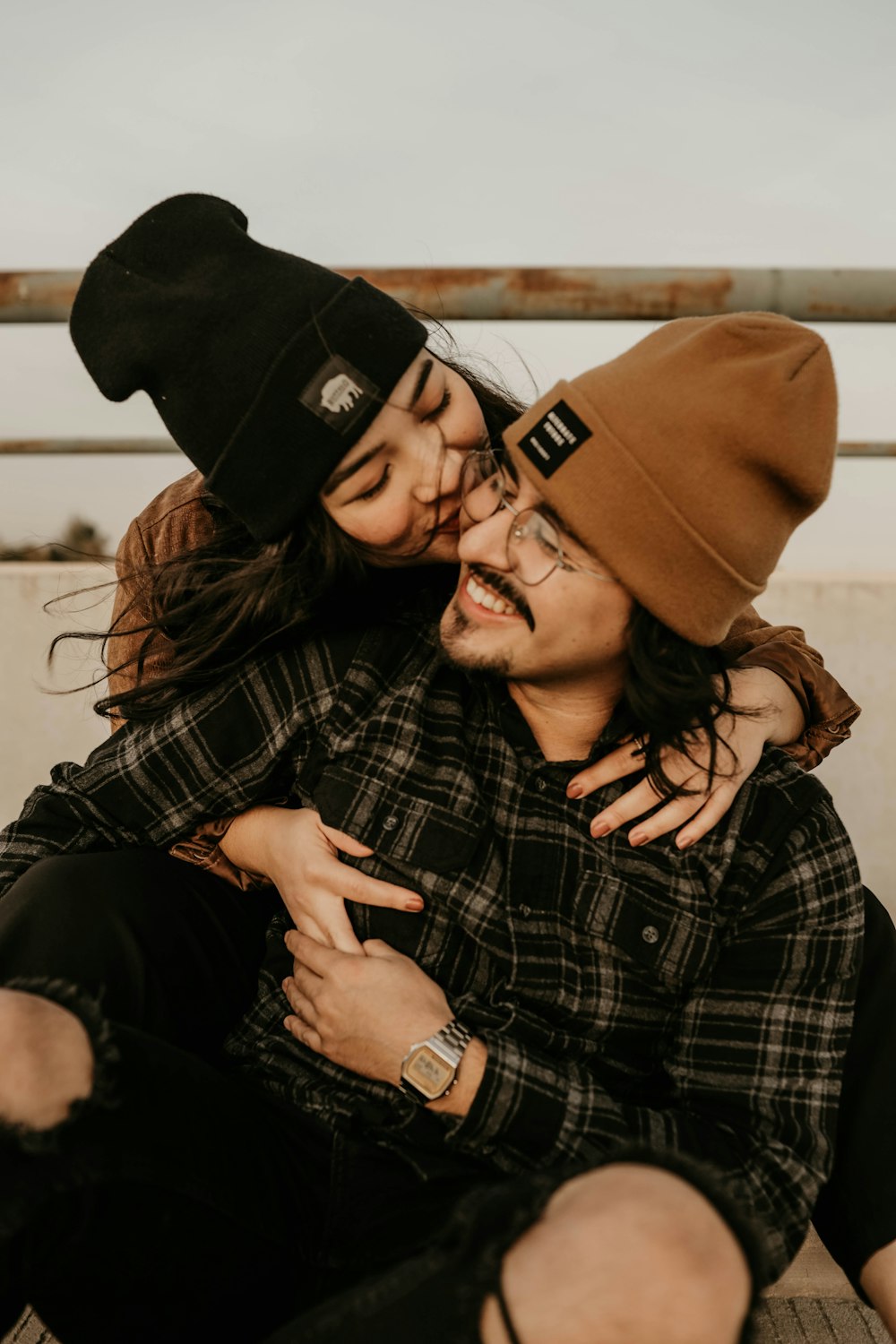 woman in black and white plaid button up shirt and black cap