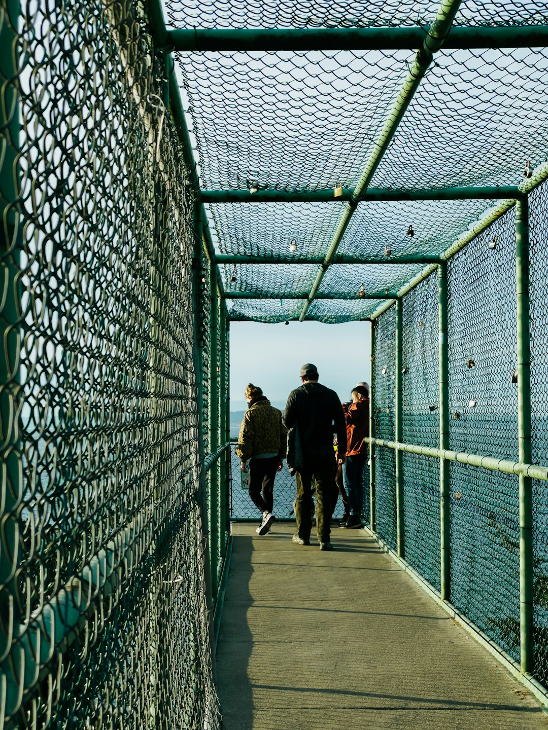 2 women walking on bridge during daytime