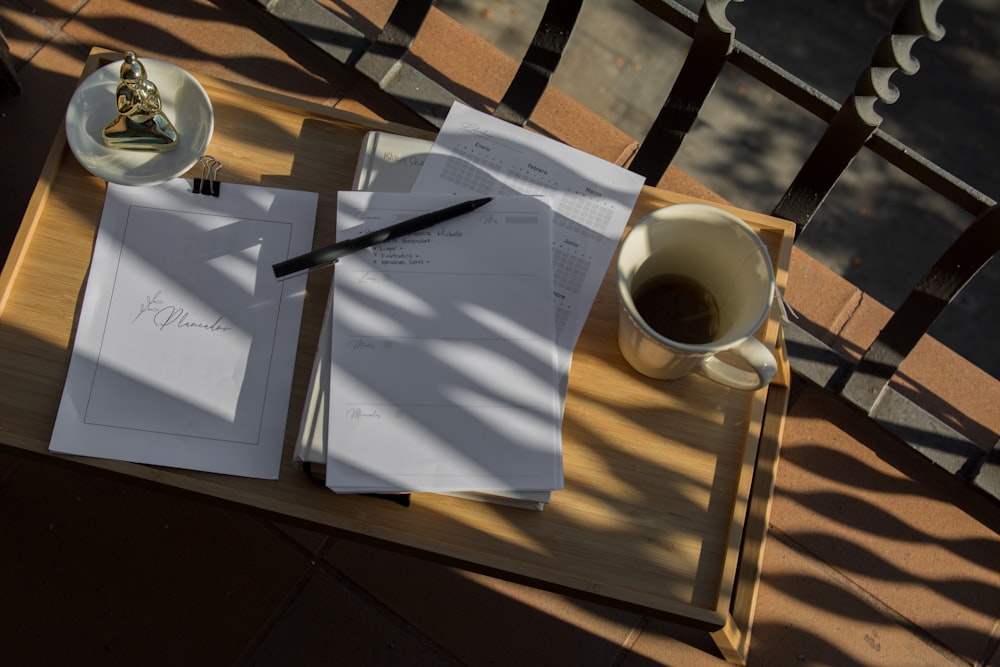 white ceramic mug on brown wooden table