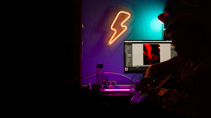 A sleek, dark-themed workspace with cyan and amber lighting highlighting guitar tools and electronic components.