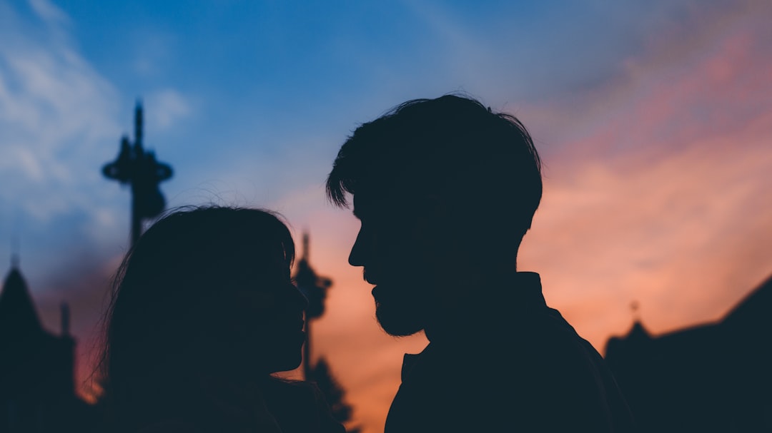 silhouette of man and woman during sunset