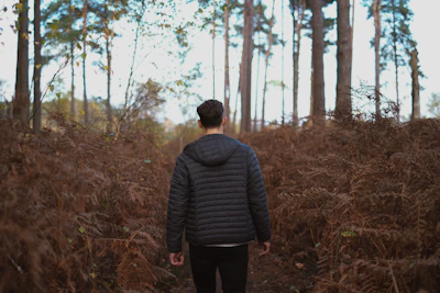 Customer wearing the flap-jacket® while hiking on a forest trail, embodying peace of mind.