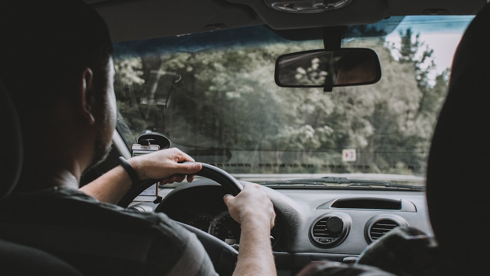 person driving car during daytime