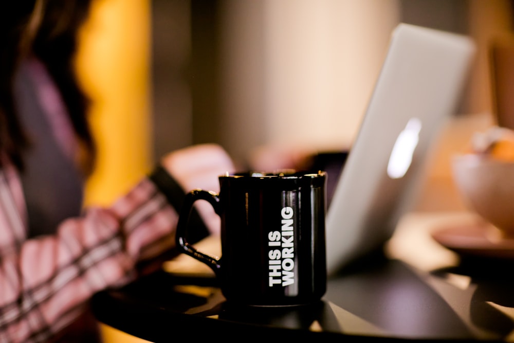 black ceramic mug on black table