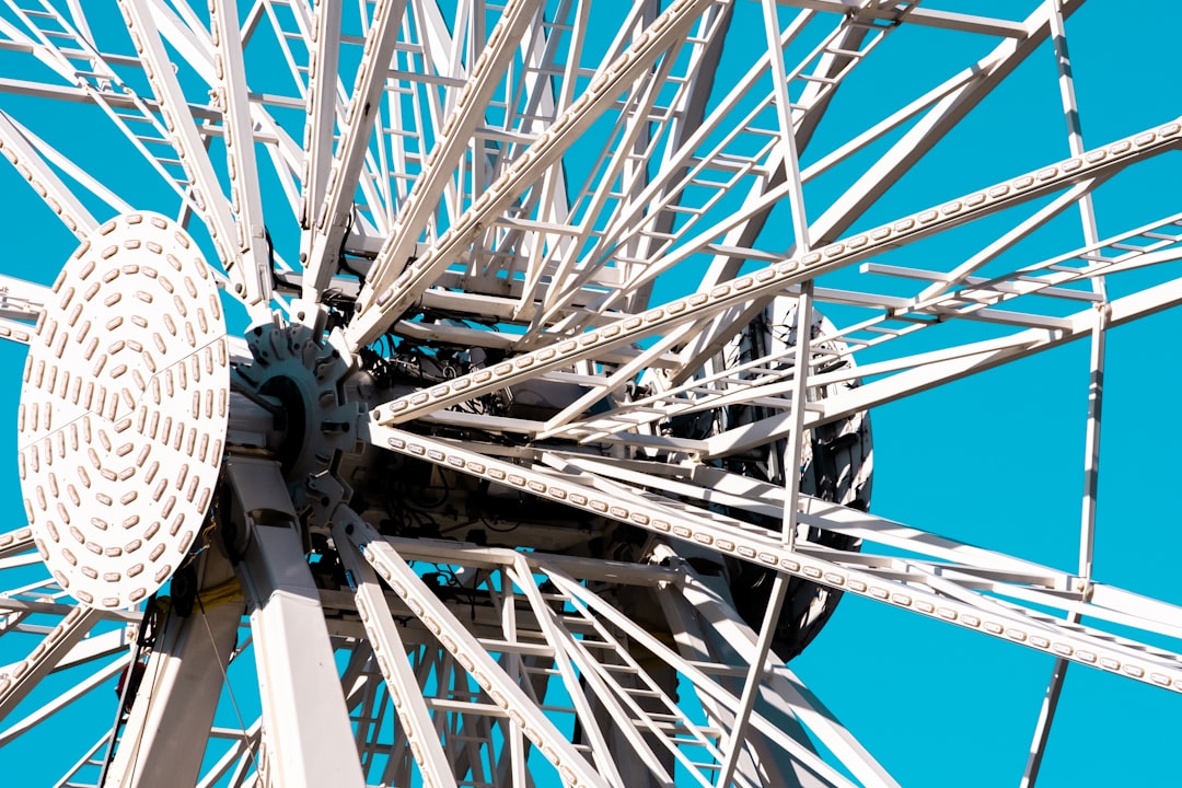 white and blue ferris wheel under blue sky during daytime