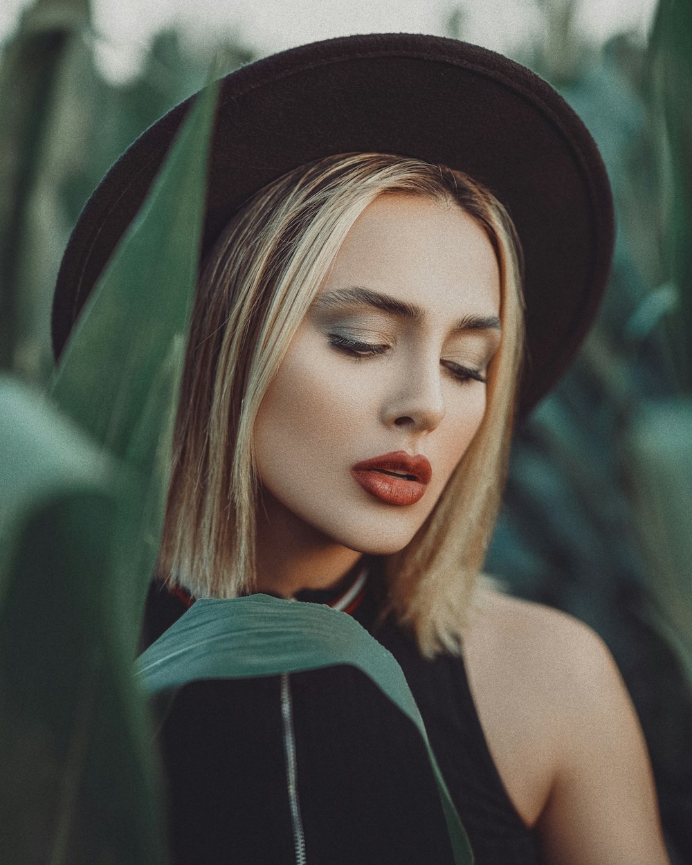 woman in black sleeveless top wearing black hat