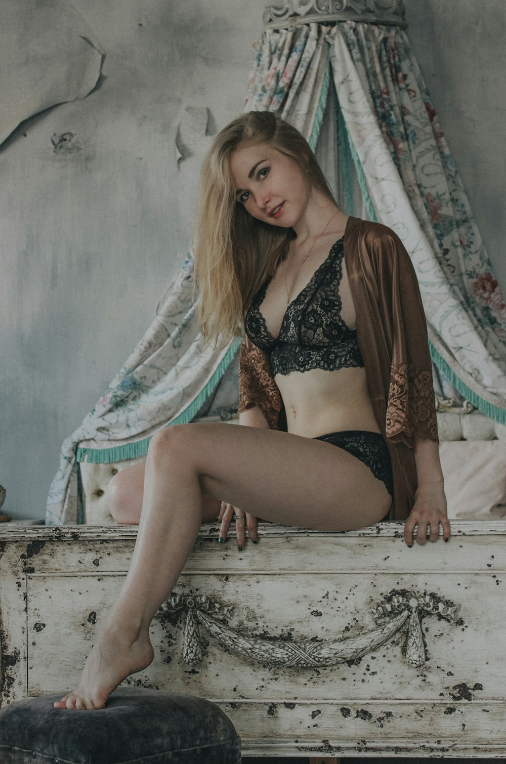 woman in black and brown floral bikini sitting on bed