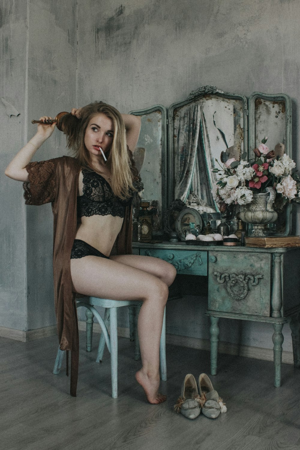 woman in black lingerie sitting on white chair