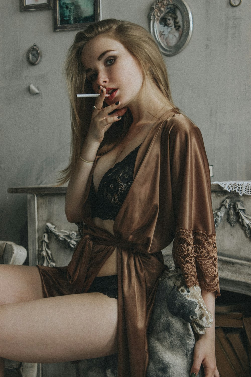 woman in brown long sleeve dress sitting on white and black floral sofa