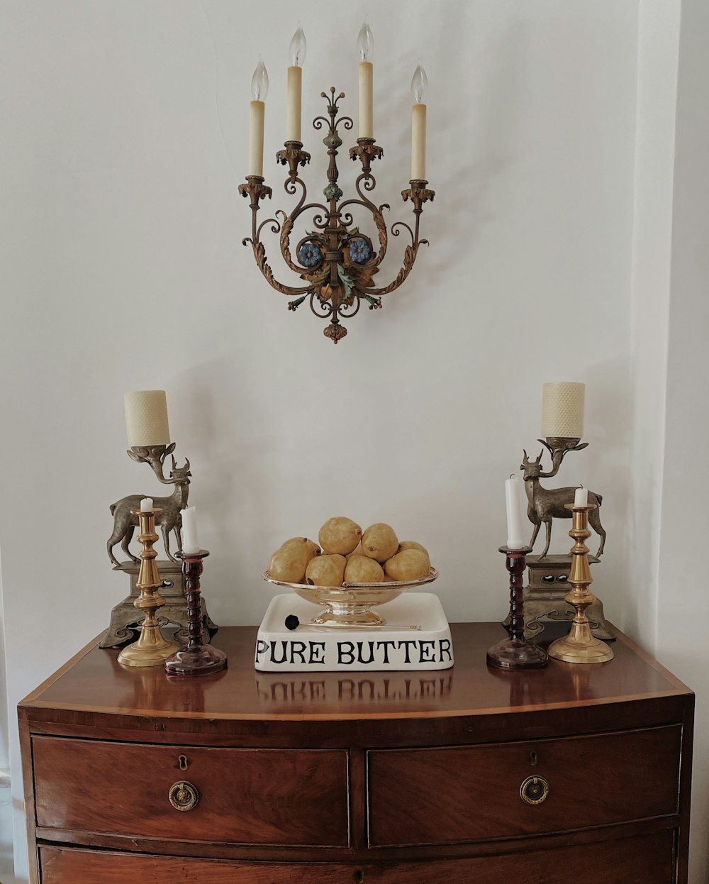 brown wooden table with brass candle holder and candles