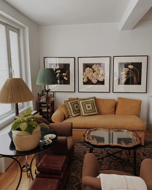 brown sofa near black metal framed glass top coffee table