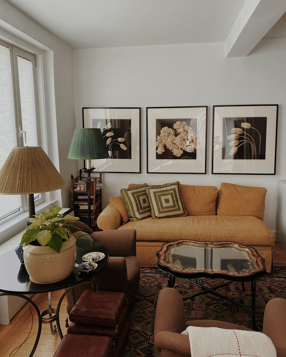 brown sofa near black metal framed glass top coffee table