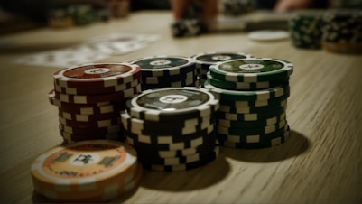 A vibrant gaming table with various casino chips and board game pieces alongside a digital wallet showing usadollartoken balance.