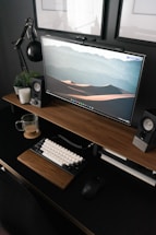 silver imac on brown wooden desk