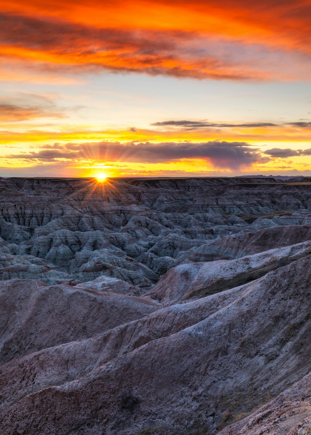 gray rocky field under orange sunset